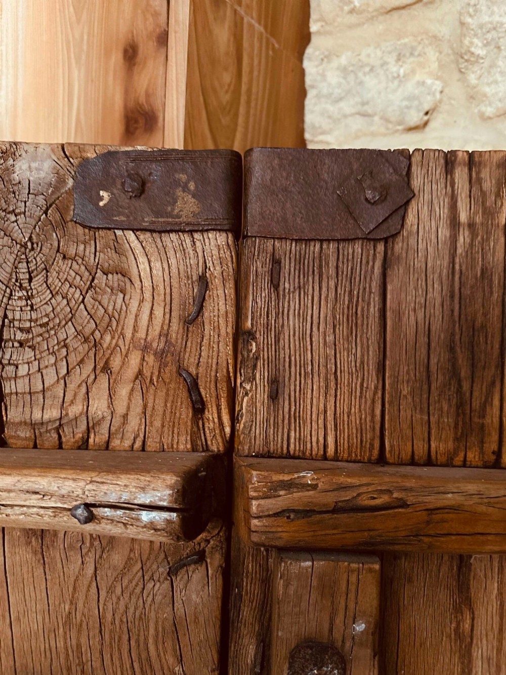 Pair of late nineteenth-century reclaimed Chinese elm doors featuring heavy iron strapping, metal studs, and central ring handles. View XIII