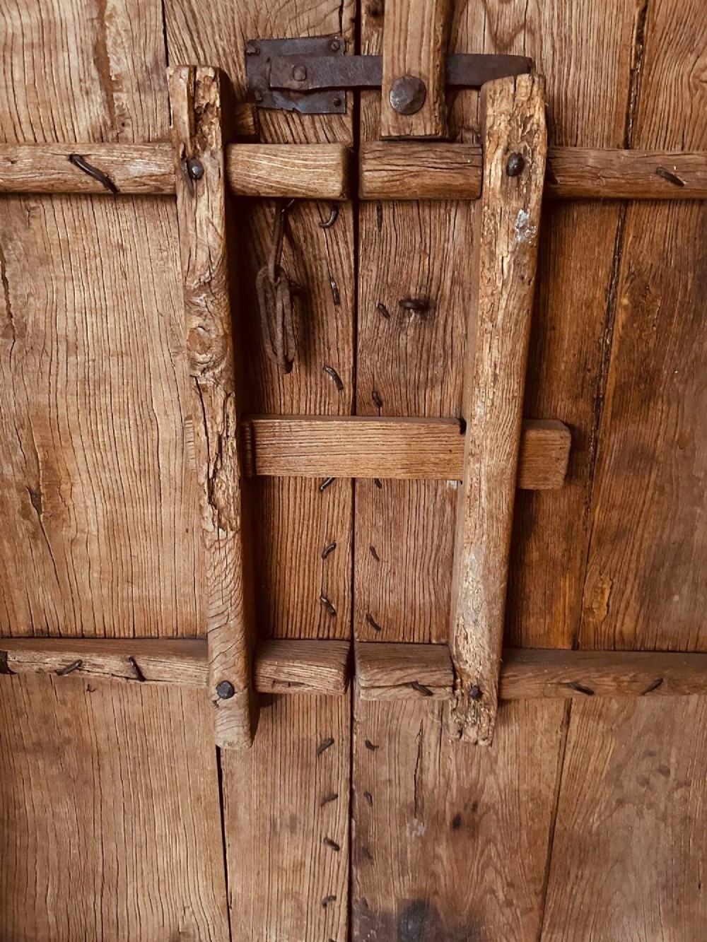 Pair of late nineteenth-century reclaimed Chinese elm doors featuring heavy iron strapping, metal studs, and central ring handles. View XIV