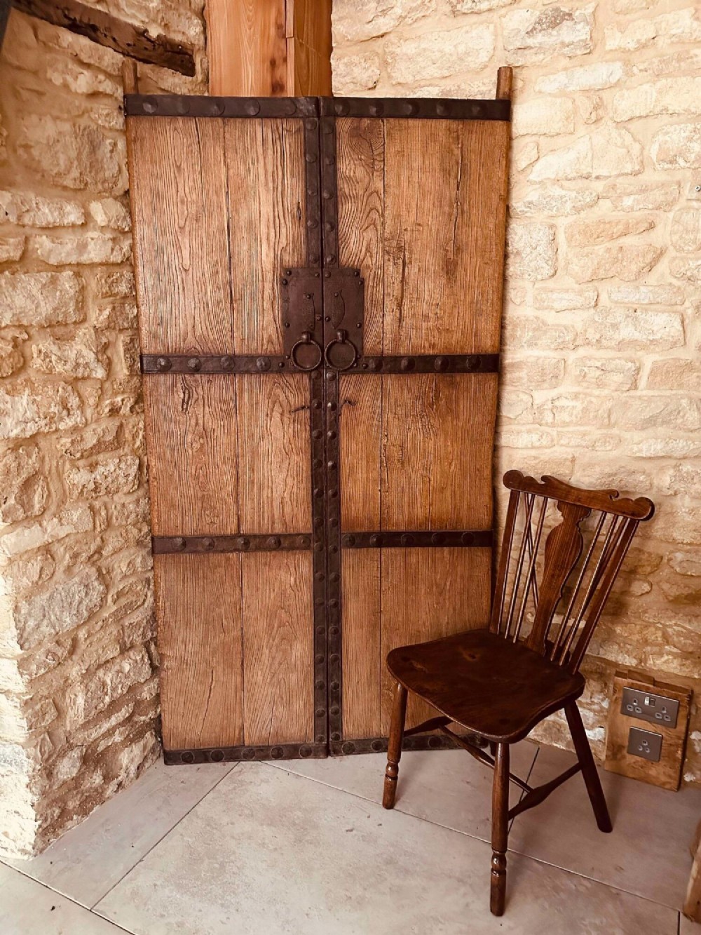 Pair of late nineteenth-century reclaimed Chinese elm doors featuring heavy iron strapping, metal studs, and central ring handles. View XV