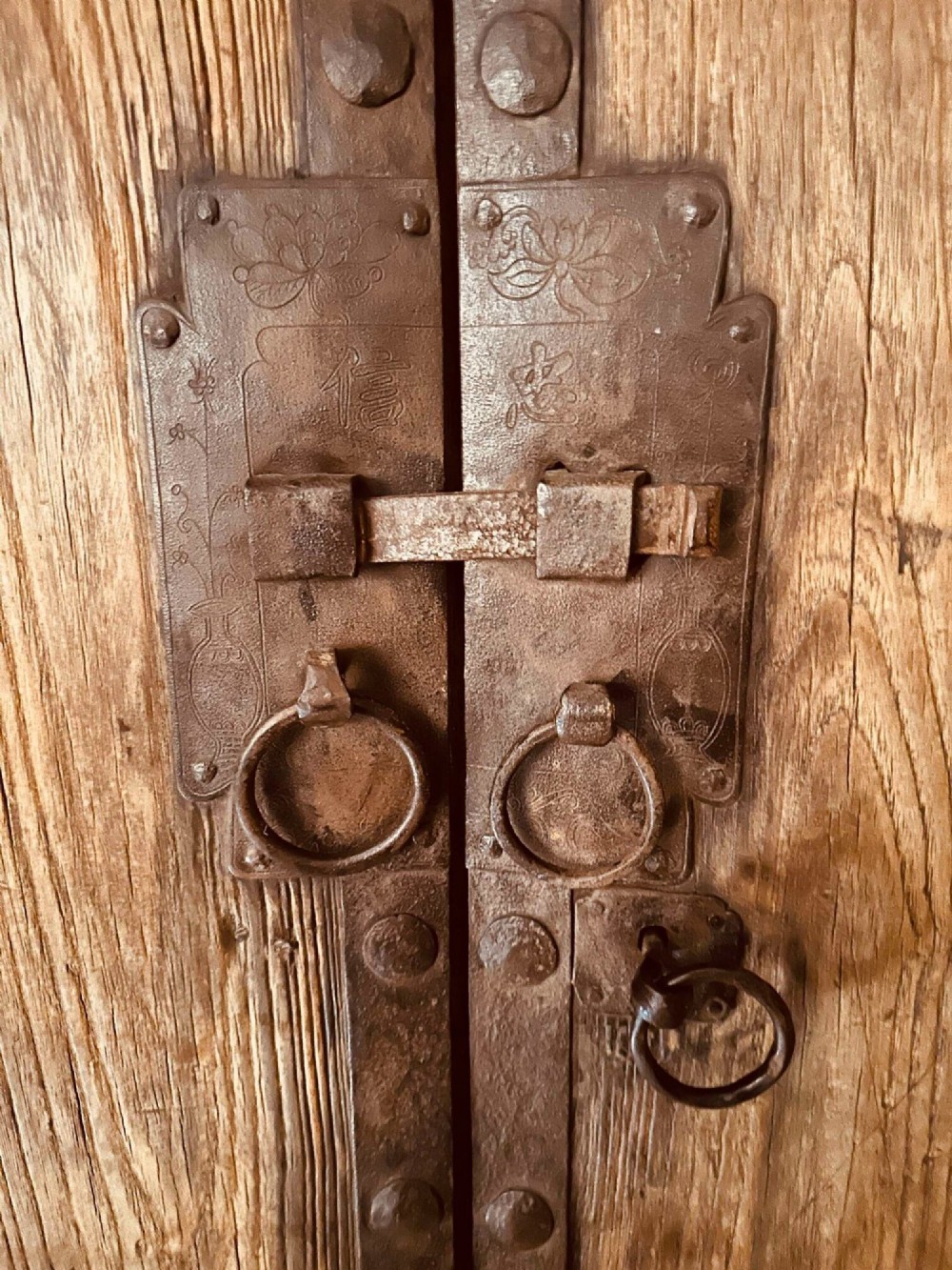 A pair of antique Chinese reclaimed locust wood doors with iron straps, decorative studs, and central ring handles. View VI