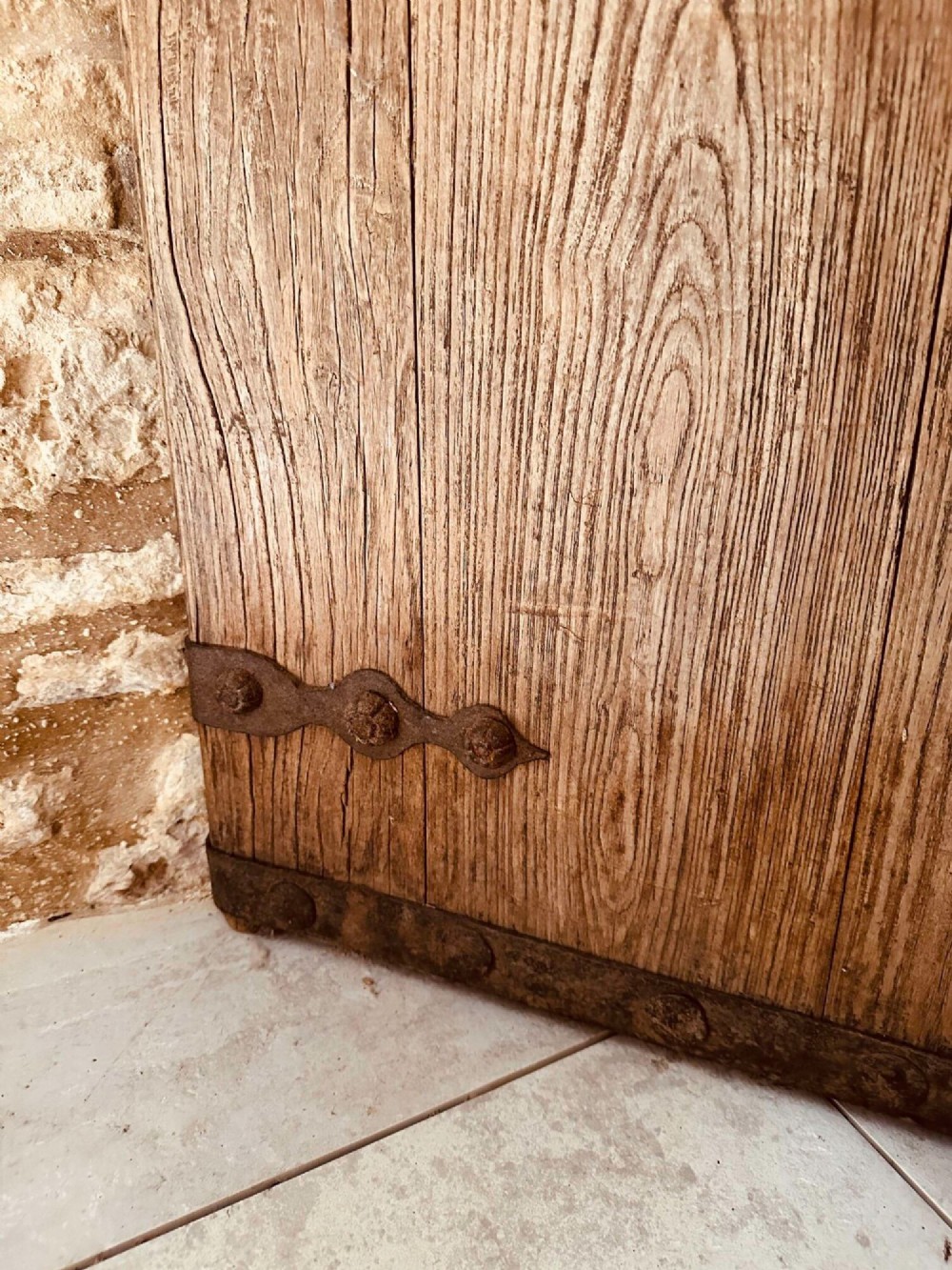 A pair of antique Chinese reclaimed locust wood doors with iron straps, decorative studs, and central ring handles. View VII
