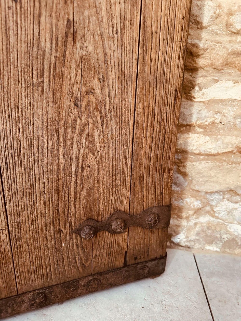 A pair of antique Chinese reclaimed locust wood doors with iron straps, decorative studs, and central ring handles. View VIII