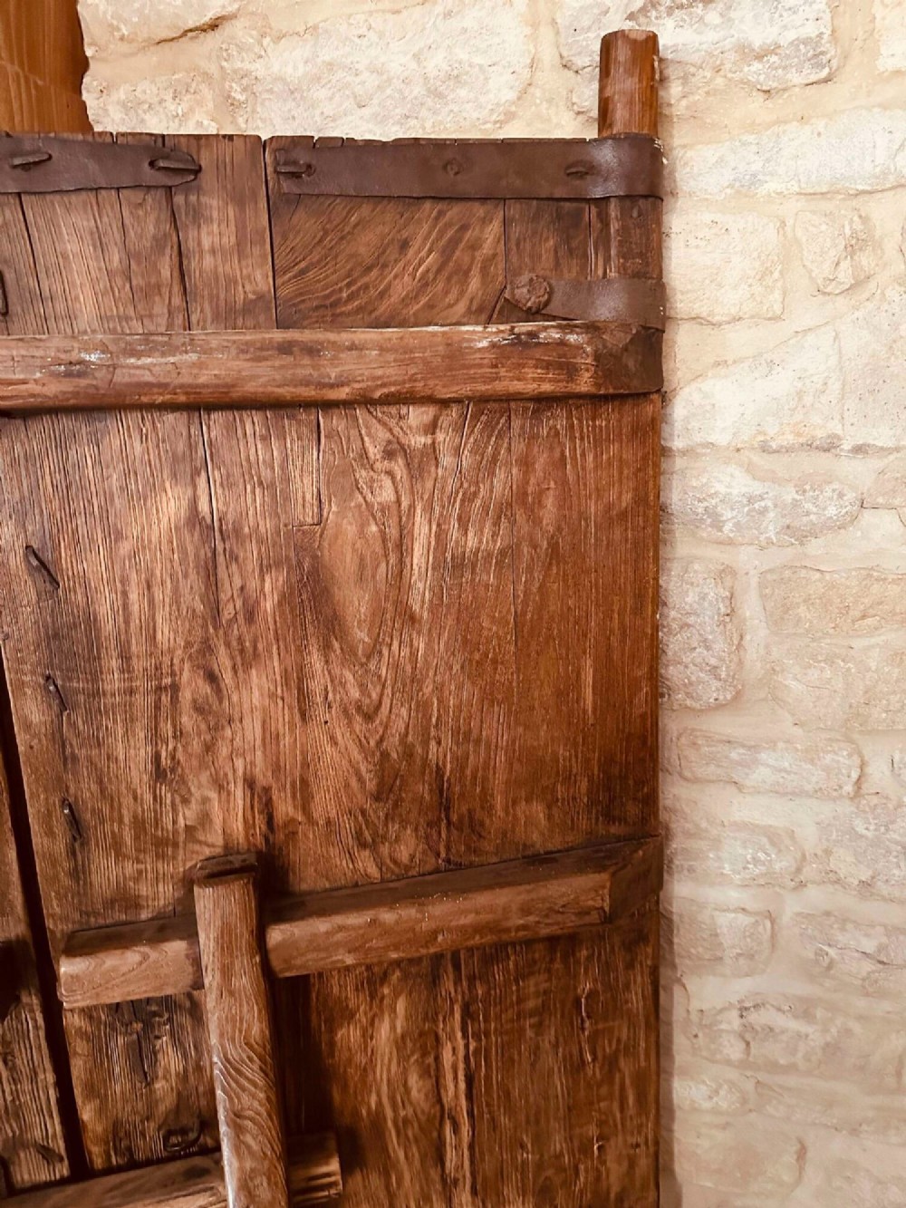 A pair of antique Chinese reclaimed locust wood doors with iron straps, decorative studs, and central ring handles. View XIII
