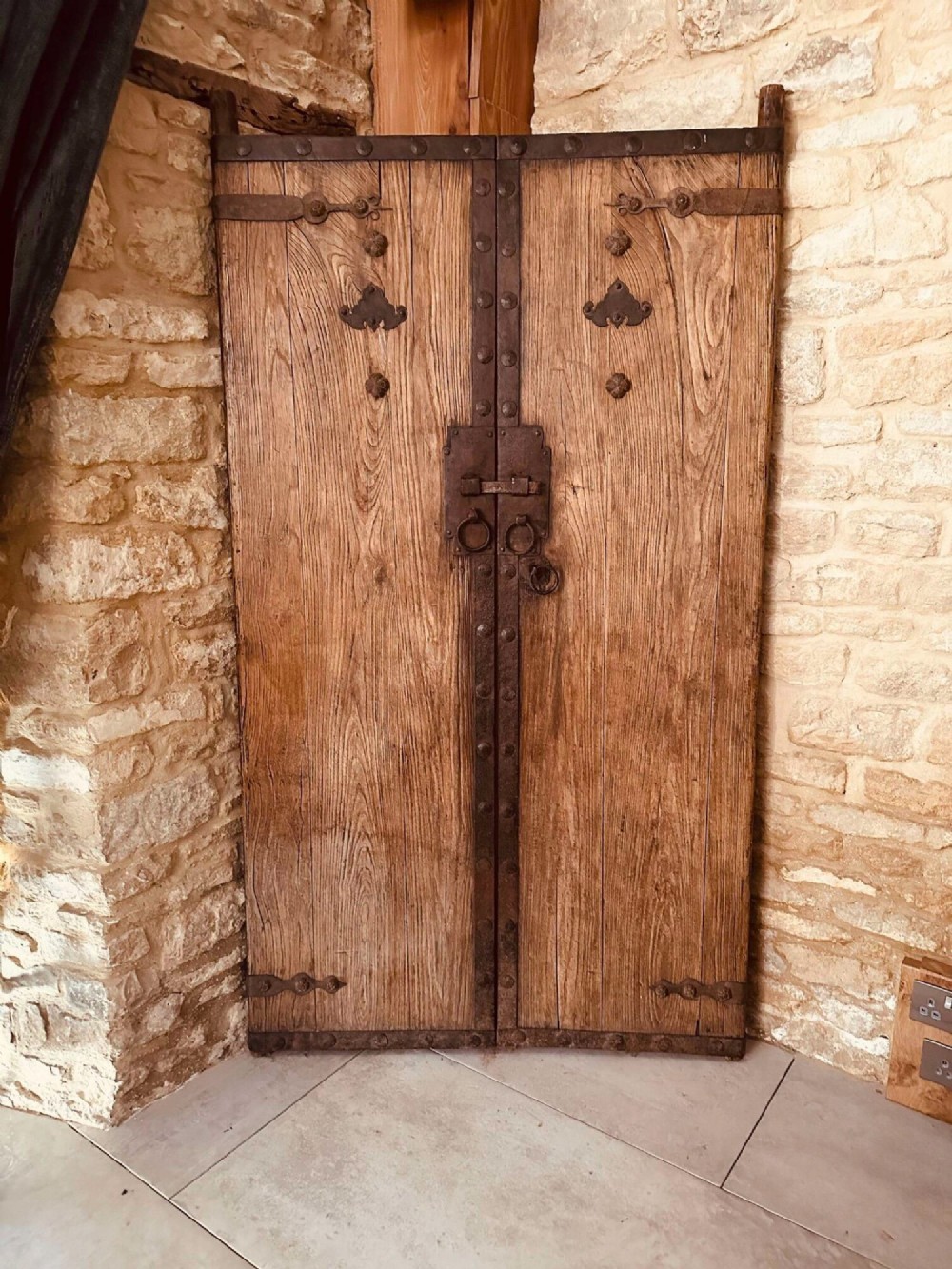 A pair of antique Chinese reclaimed locust wood doors with iron straps, decorative studs, and central ring handles. View XIV