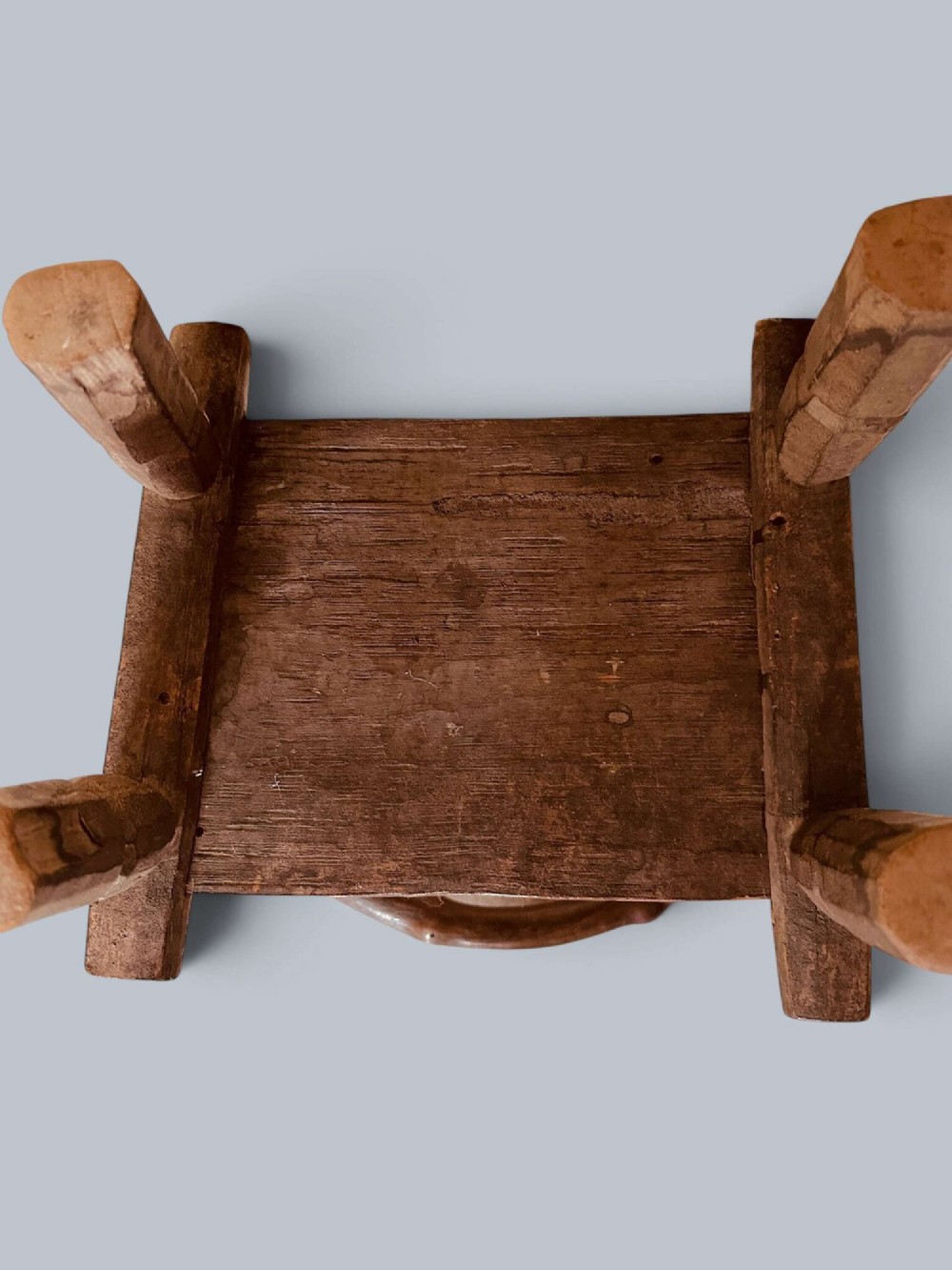 A small hand-carved rustic wooden child chair with a curved branch backrest and chunky square-cut legs. View XI