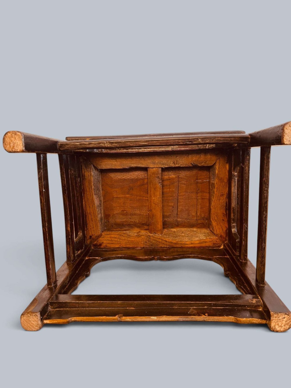 A pair of dark-lacquered antique Chinese childrens chairs with yoke-style top rails and carved aprons. View XI