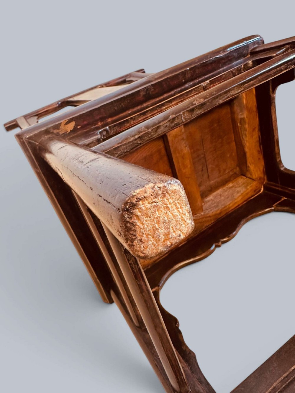 A pair of dark-lacquered antique Chinese childrens chairs with yoke-style top rails and carved aprons. View XII