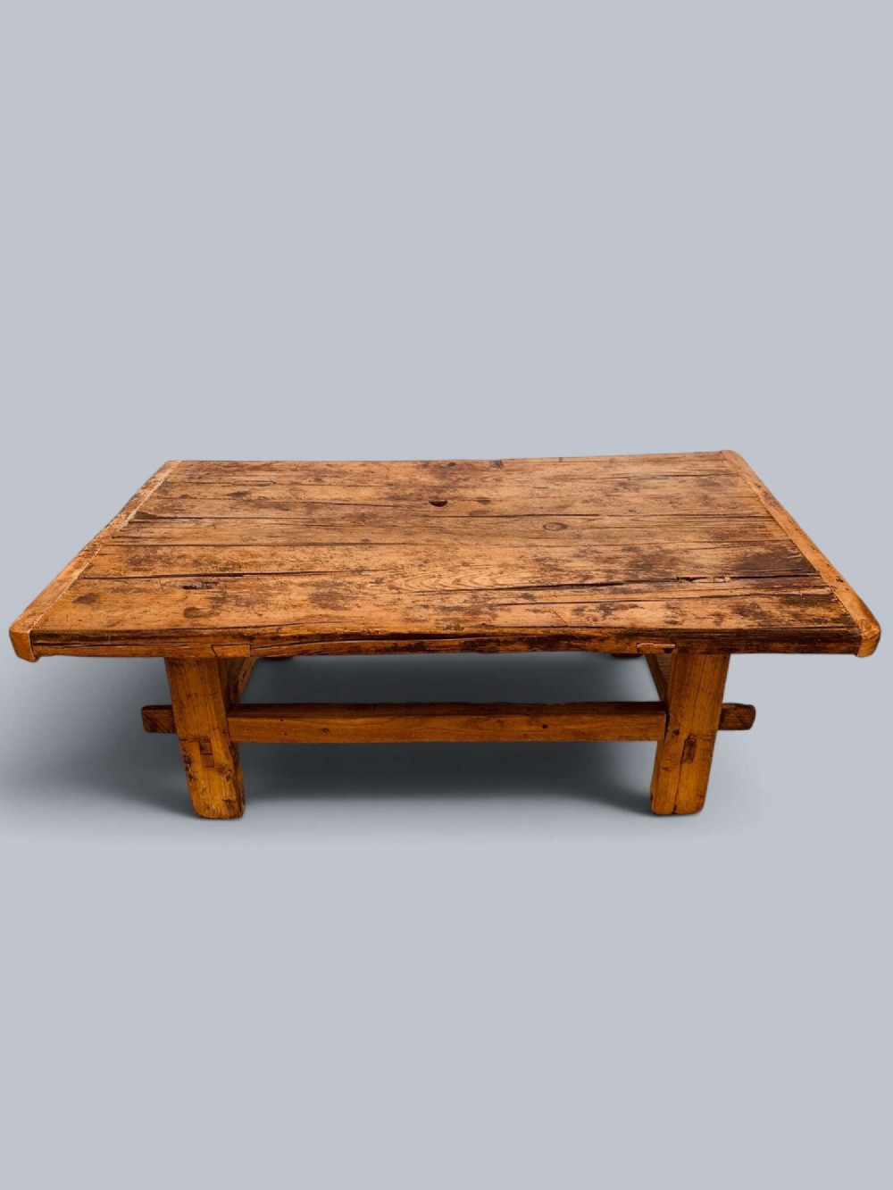 A low rustic pine market table featuring thick block legs, exposed mortise and tenon joinery, and a weathered wood top. View II