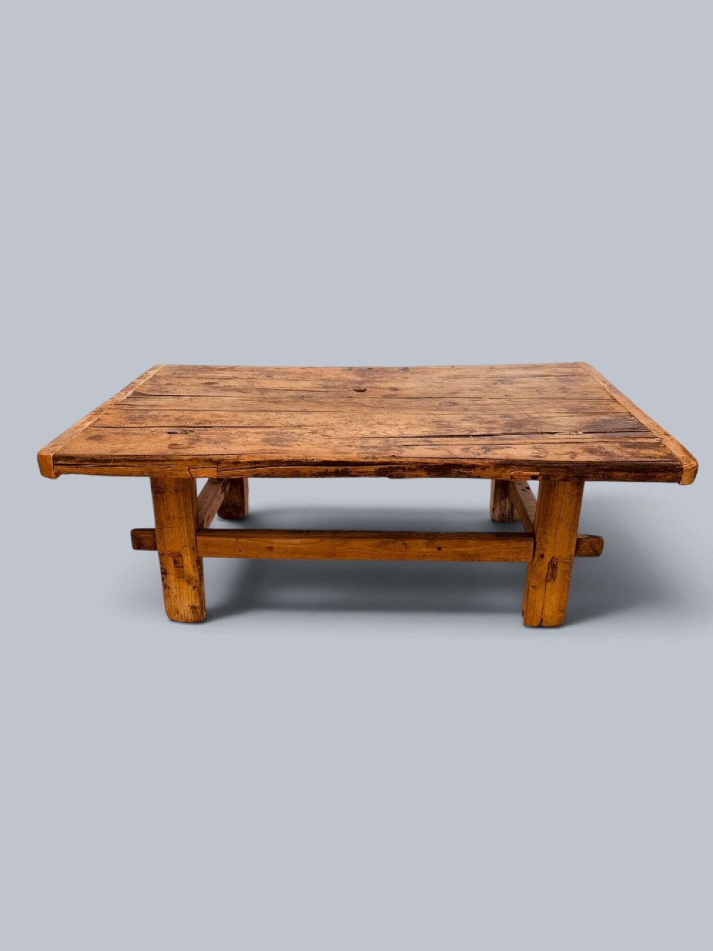 A low rustic pine market table featuring thick block legs, exposed mortise and tenon joinery, and a weathered wood top. View IV