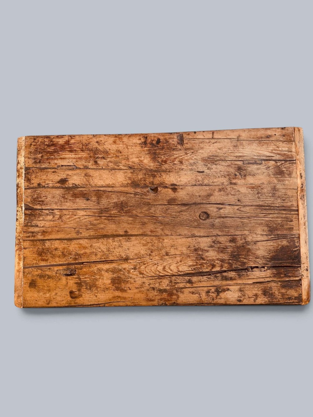 A low rustic pine market table featuring thick block legs, exposed mortise and tenon joinery, and a weathered wood top. View V