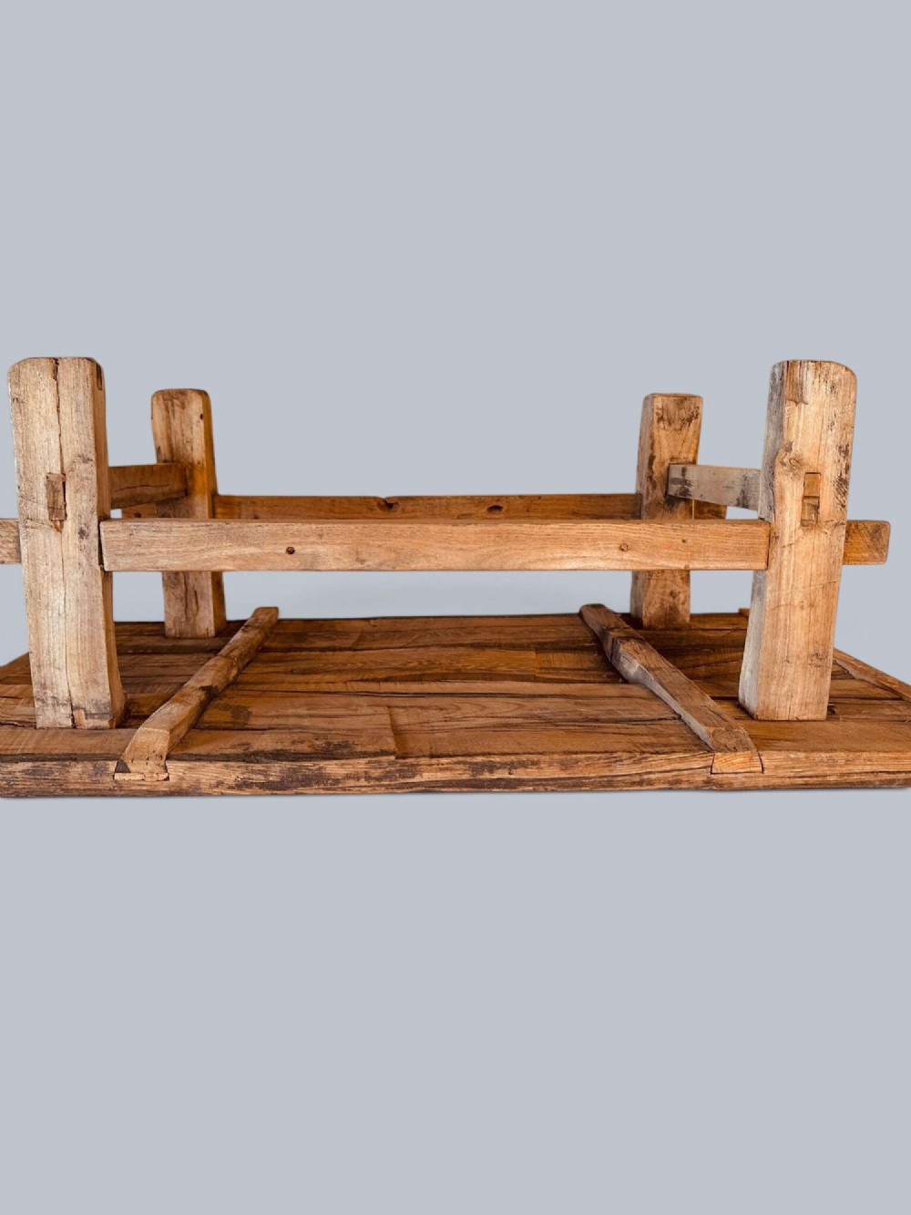 A low rustic pine market table featuring thick block legs, exposed mortise and tenon joinery, and a weathered wood top. View IX
