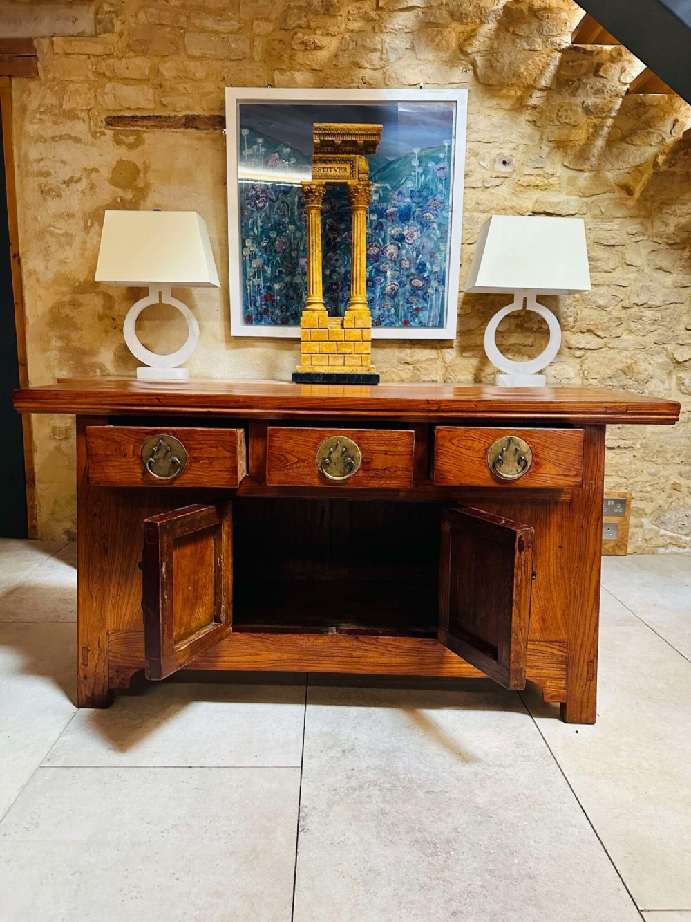 A warm brown Chinese elm altar cabinet featuring three upper drawers, two central cupboard doors, and round brass hardware. View V