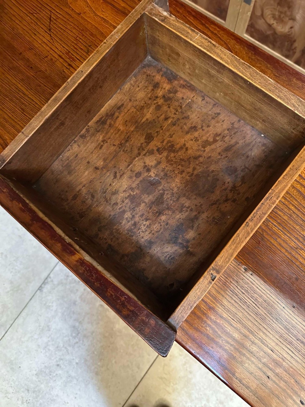 A warm brown Chinese elm altar cabinet featuring three upper drawers, two central cupboard doors, and round brass hardware. View VIII