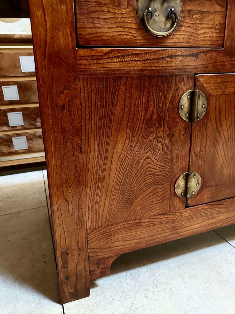 A warm brown Chinese elm altar cabinet featuring three upper drawers, two central cupboard doors, and round brass hardware. View XI