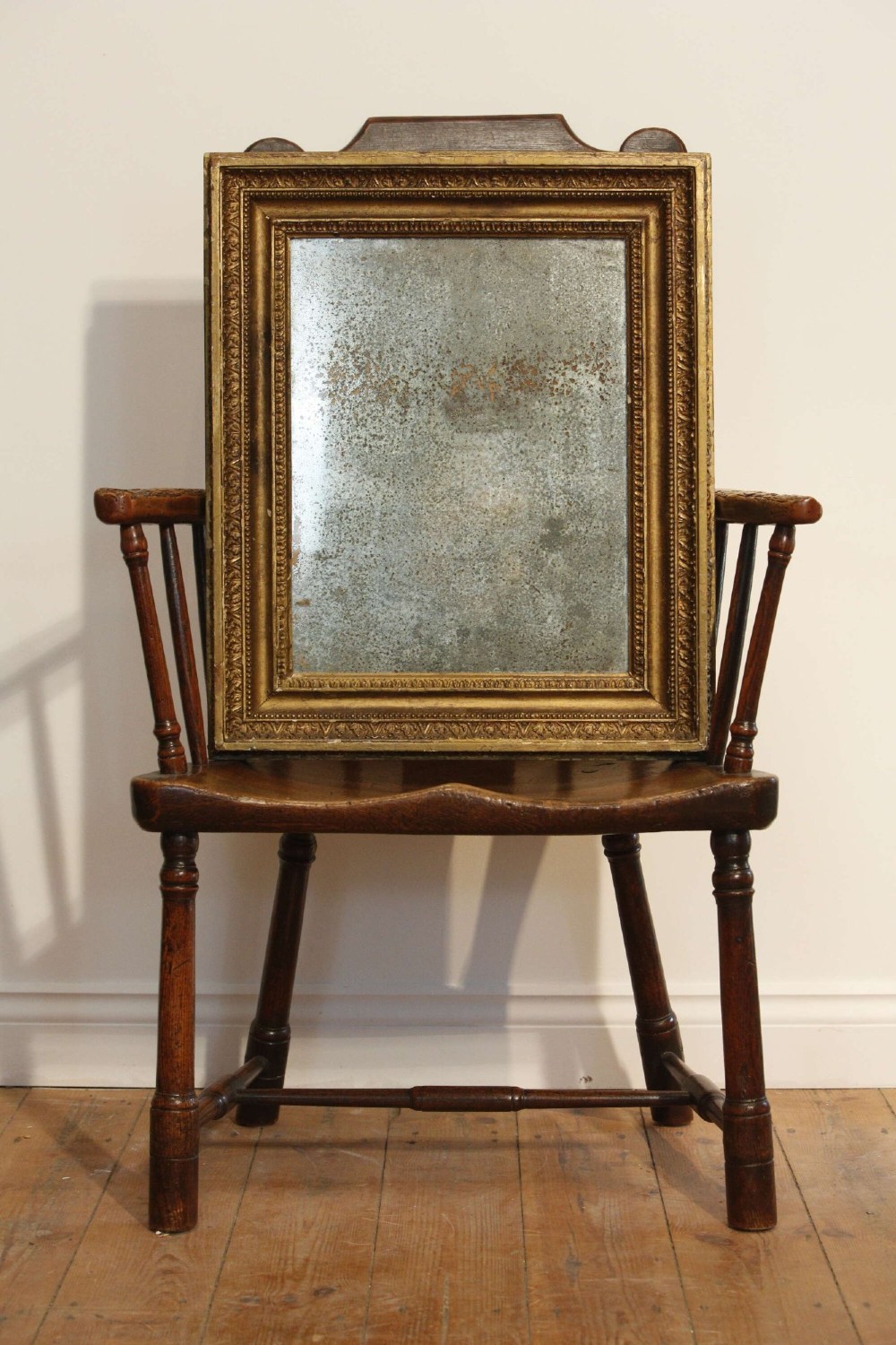 A 19th-century French rectangular giltwood wall mirror featuring a moulded frame with detailed borders and a heavily foxed glass plate. View VI