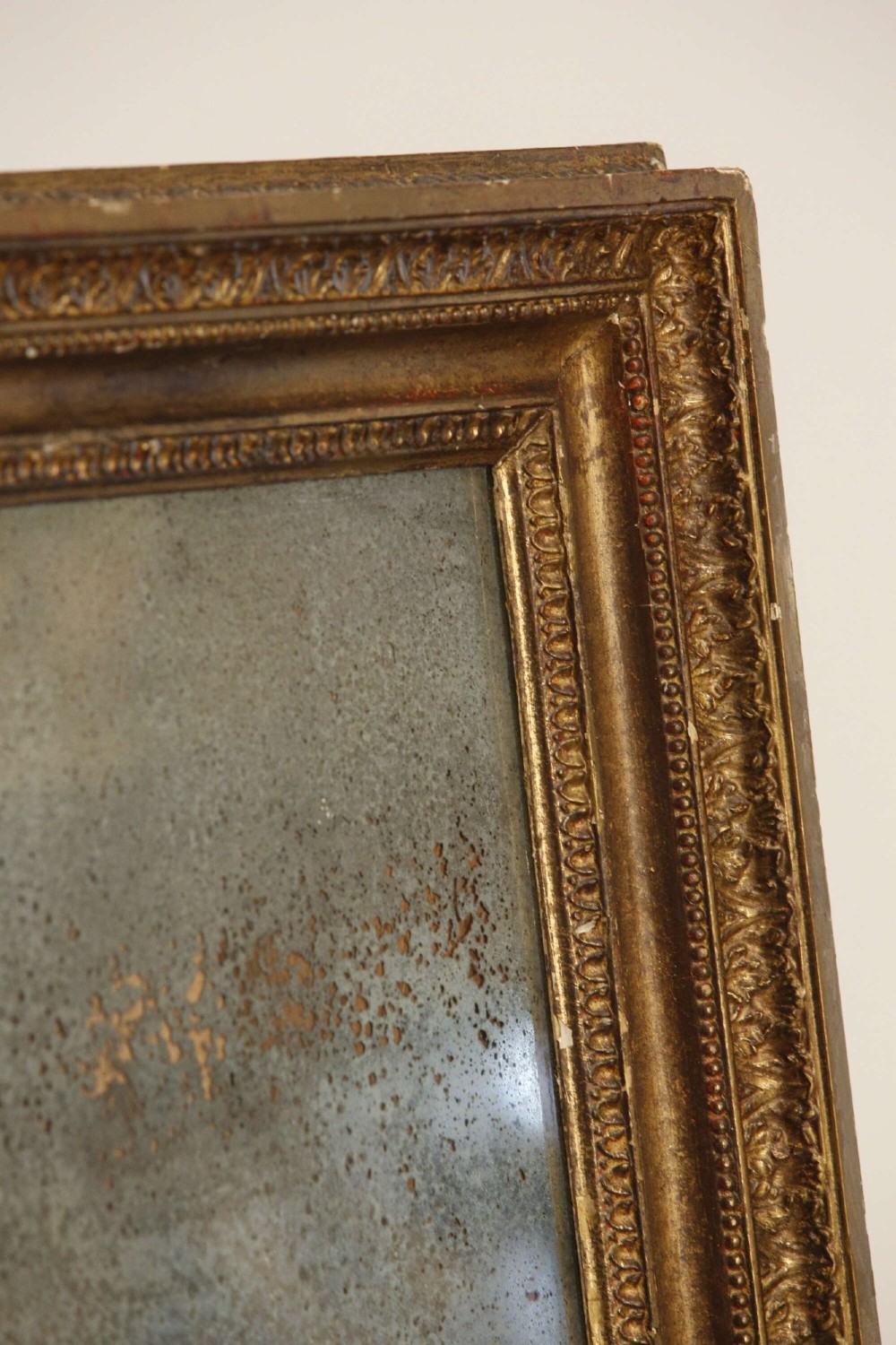 A 19th-century French rectangular giltwood wall mirror featuring a moulded frame with detailed borders and a heavily foxed glass plate. View VIII