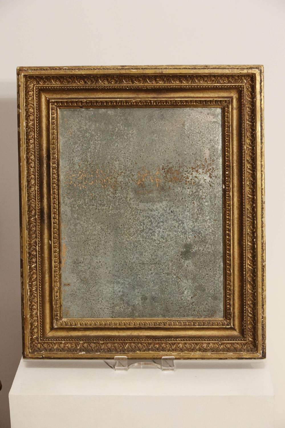 A 19th-century French rectangular giltwood wall mirror featuring a moulded frame with detailed borders and a heavily foxed glass plate. View IX