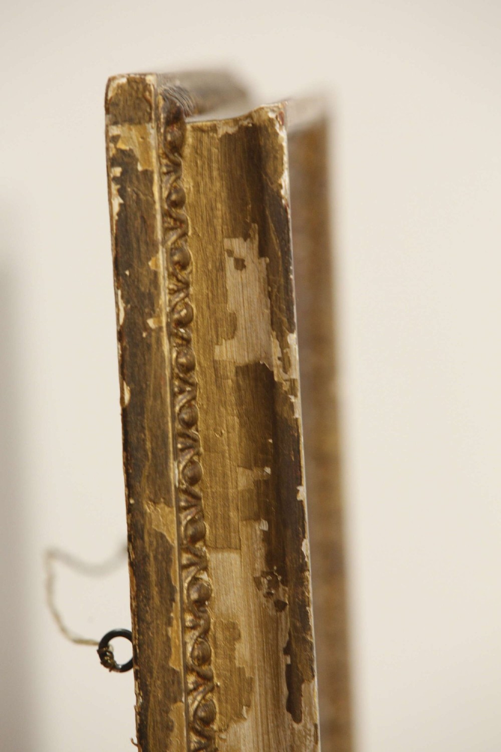 A 19th-century French rectangular giltwood wall mirror featuring a moulded frame with detailed borders and a heavily foxed glass plate. View X