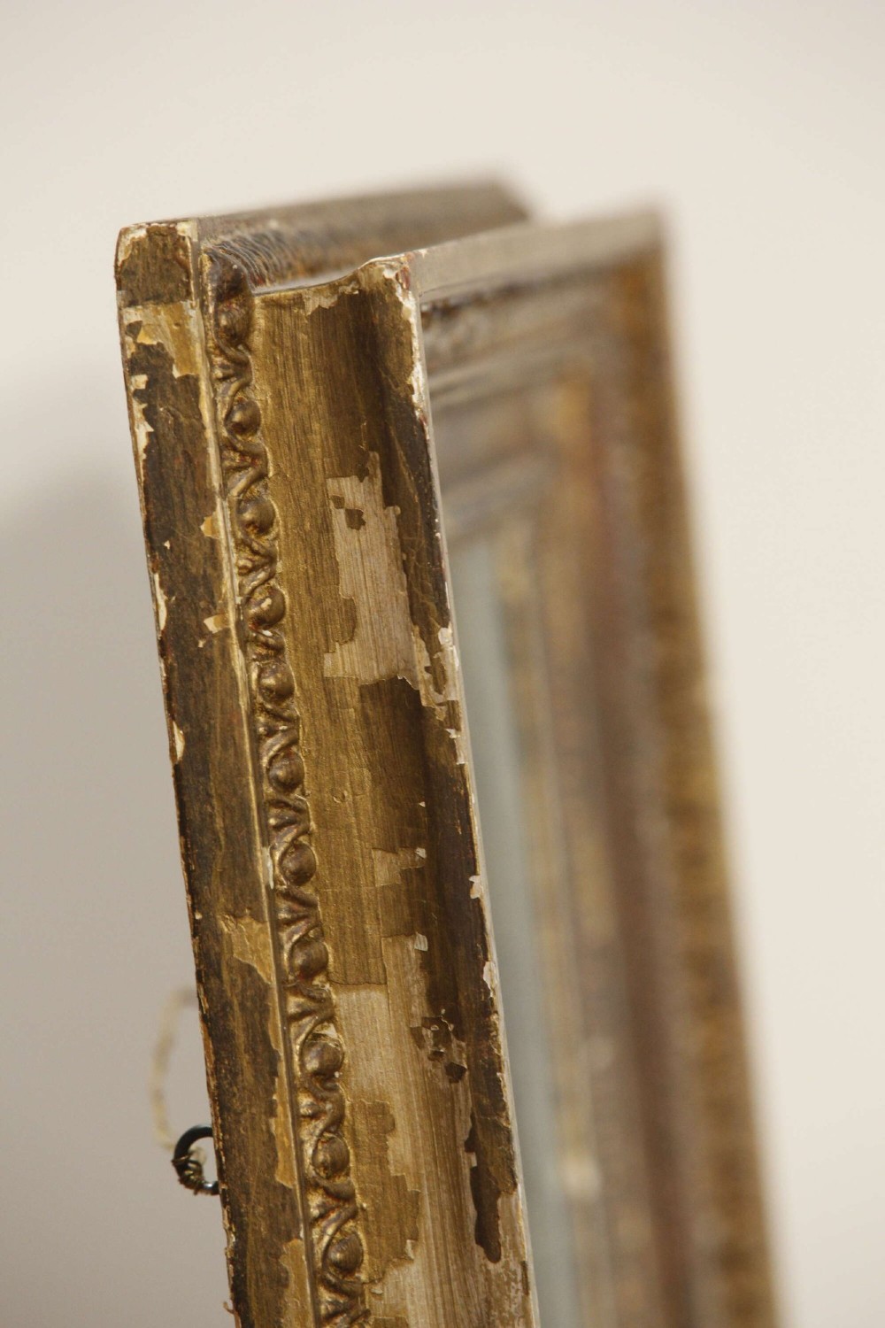 A 19th-century French rectangular giltwood wall mirror featuring a moulded frame with detailed borders and a heavily foxed glass plate. View XI
