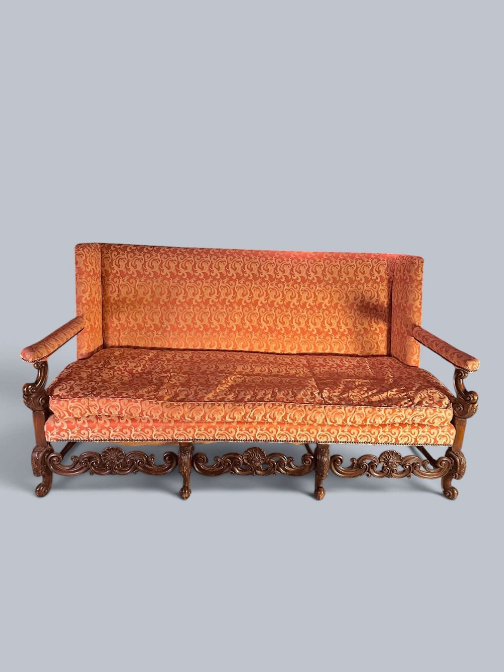 Late 19th-century Louis XIV style walnut sofa with intricately carved stretchers and red patterned damask fabric. View III