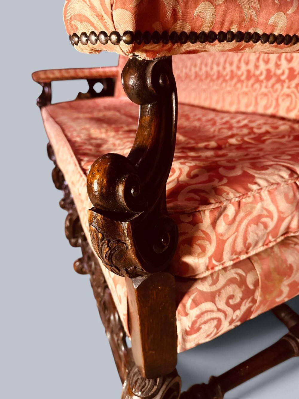 Late 19th-century Louis XIV style walnut sofa with intricately carved stretchers and red patterned damask fabric. View VII