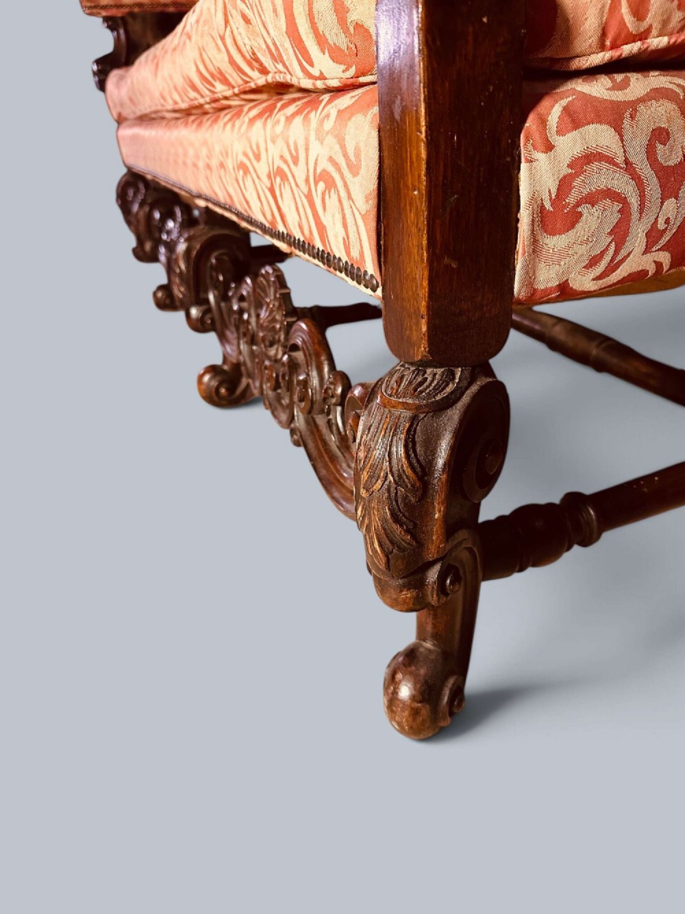 Late 19th-century Louis XIV style walnut sofa with intricately carved stretchers and red patterned damask fabric. View VIII