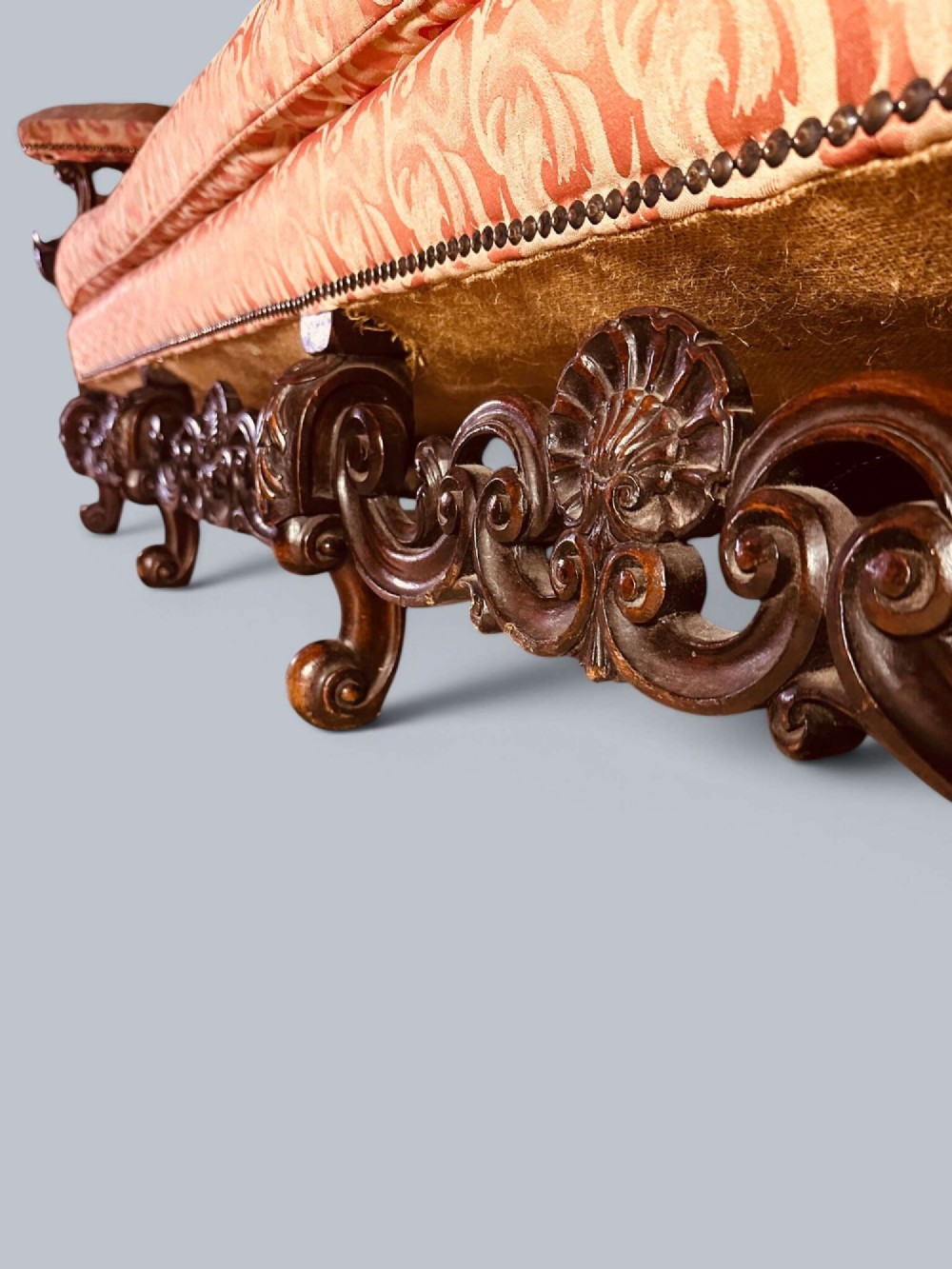 Late 19th-century Louis XIV style walnut sofa with intricately carved stretchers and red patterned damask fabric. View IX