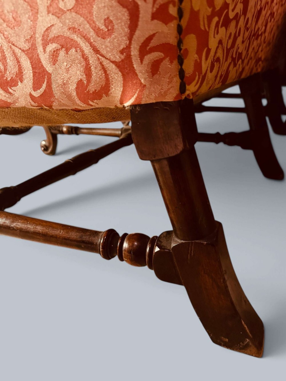 Late 19th-century Louis XIV style walnut sofa with intricately carved stretchers and red patterned damask fabric. View XII