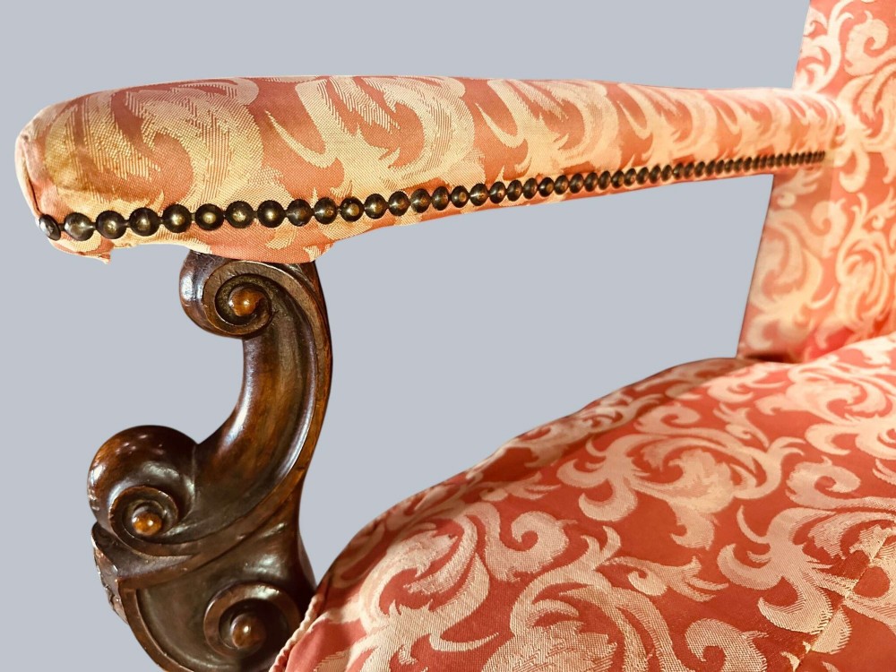 Late 19th-century Louis XIV style walnut sofa with intricately carved stretchers and red patterned damask fabric. View XIII