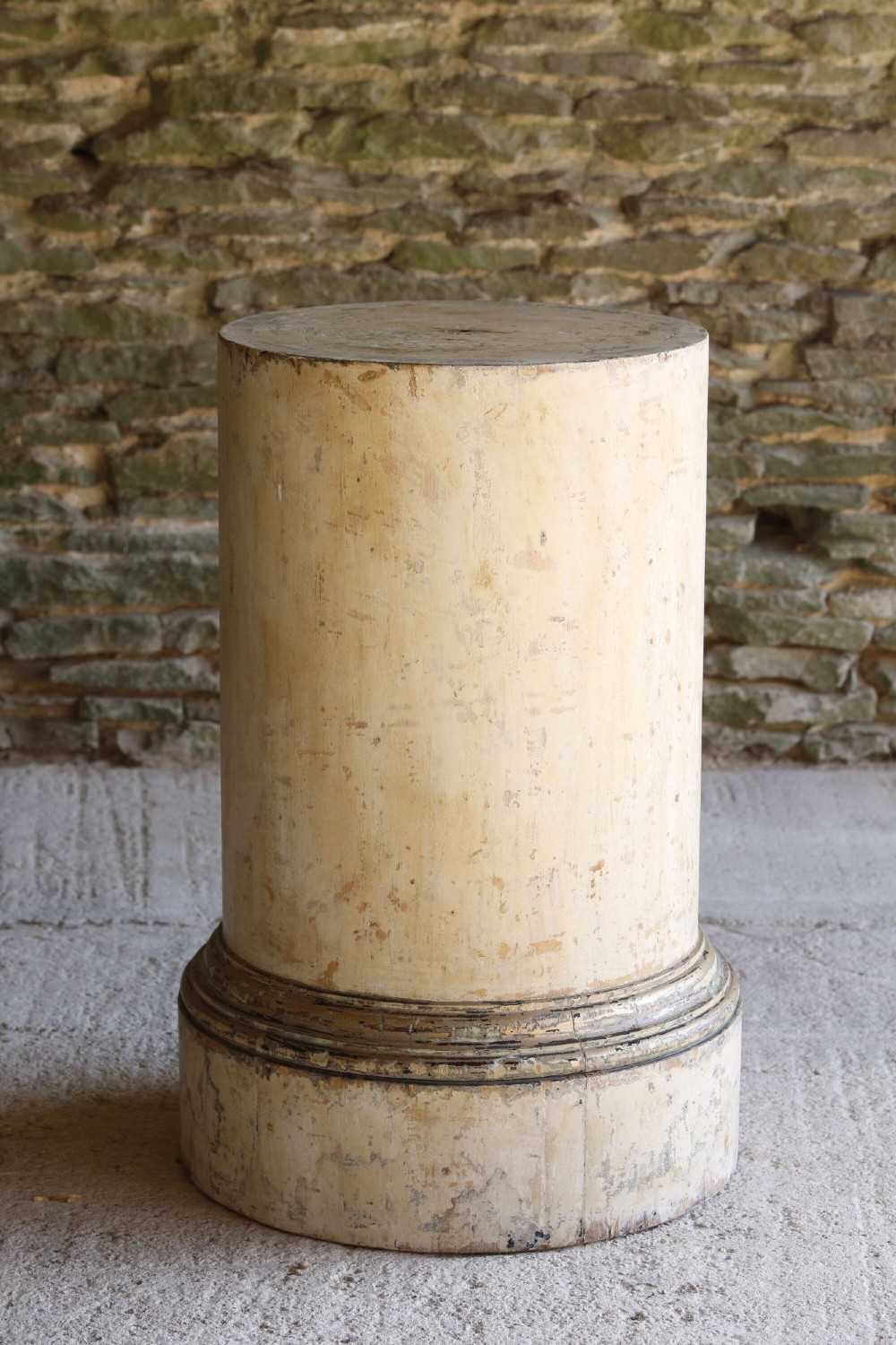 A cylindrical 18th-century Neoclassical painted pine column pedestal with a stepped moulded base and a weathered cream paint finish. View II