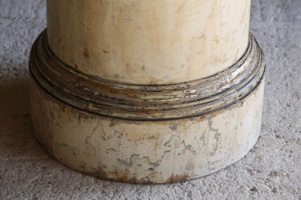 A cylindrical 18th-century Neoclassical painted pine column pedestal with a stepped moulded base and a weathered cream paint finish. View IV