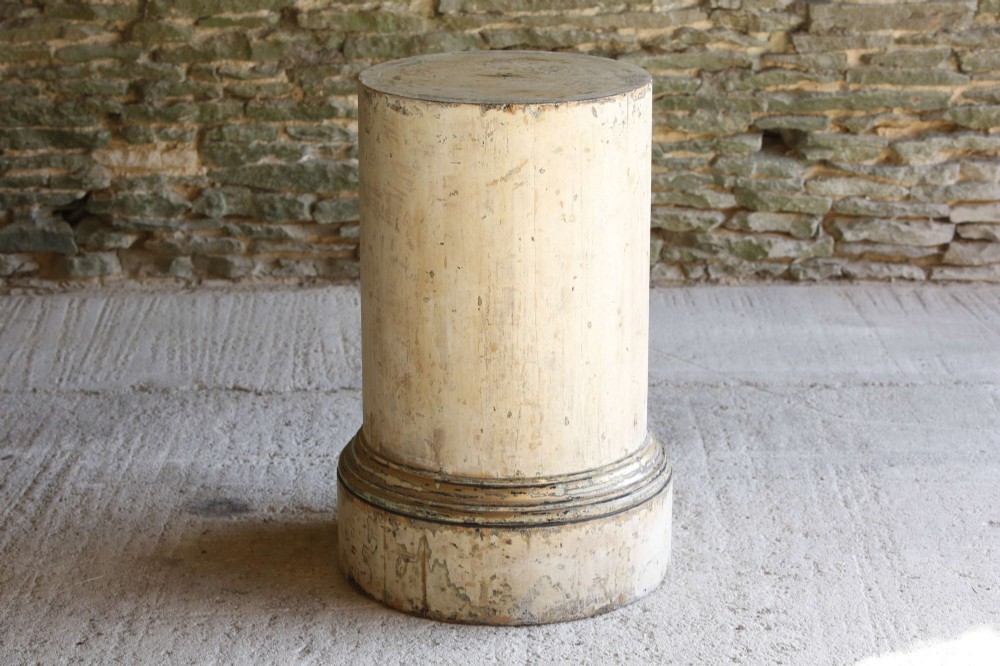 A cylindrical 18th-century Neoclassical painted pine column pedestal with a stepped moulded base and a weathered cream paint finish. View VI