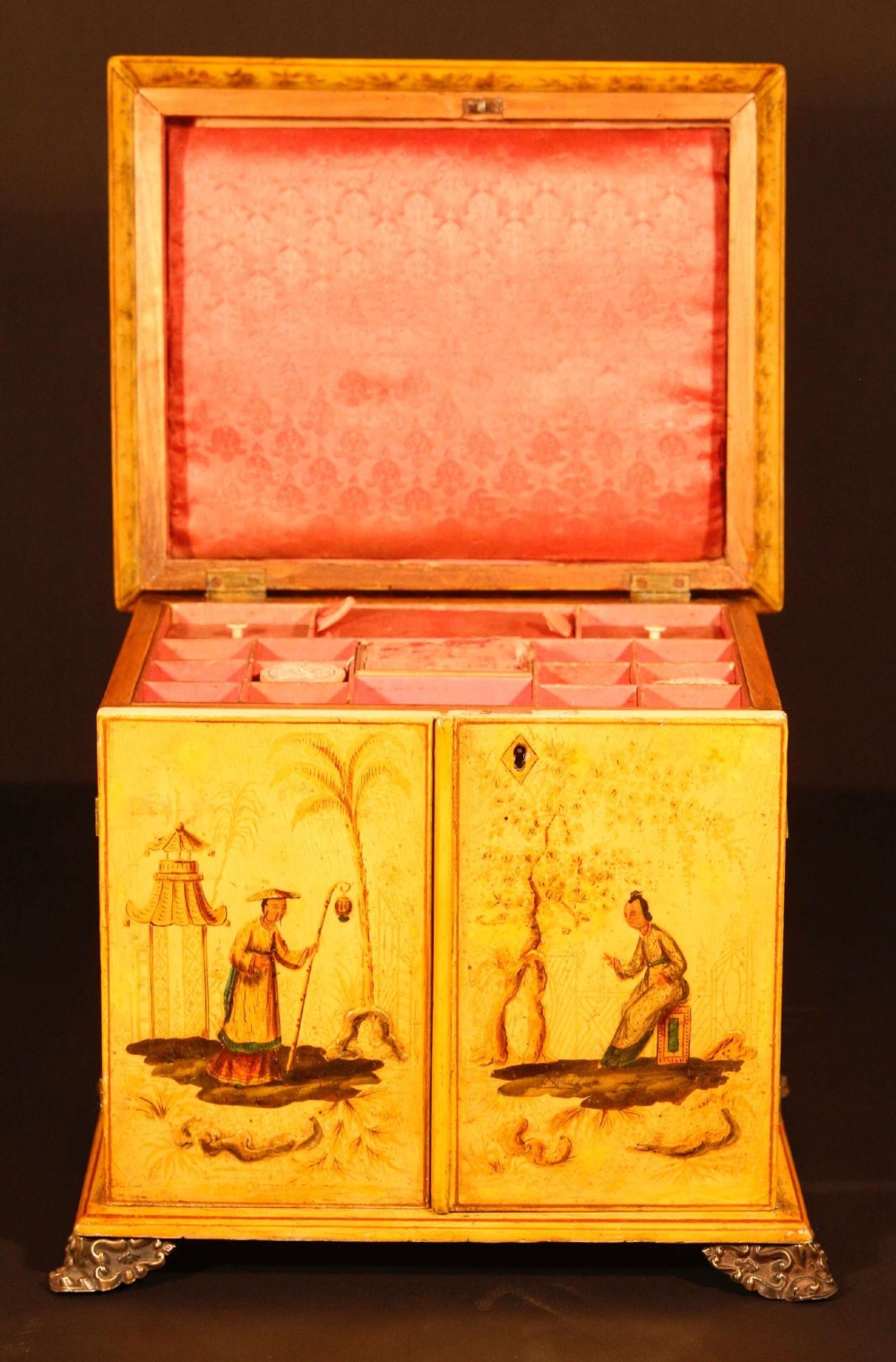 A yellow japanned Regency table cabinet decorated with hand-painted Chinoiserie figures and architecture, elevated on ornate metal feet. View II