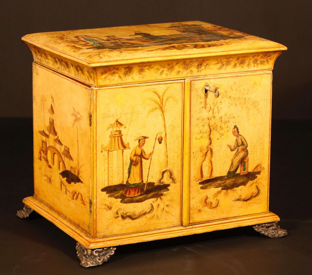 A yellow japanned Regency table cabinet decorated with hand-painted Chinoiserie figures and architecture, elevated on ornate metal feet. View III