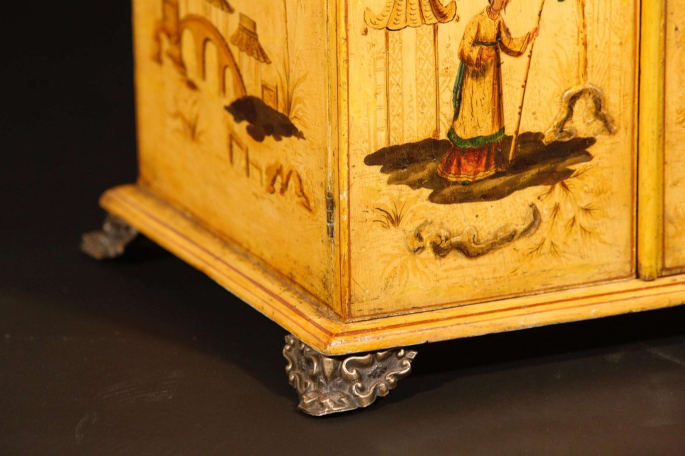 A yellow japanned Regency table cabinet decorated with hand-painted Chinoiserie figures and architecture, elevated on ornate metal feet. View IV