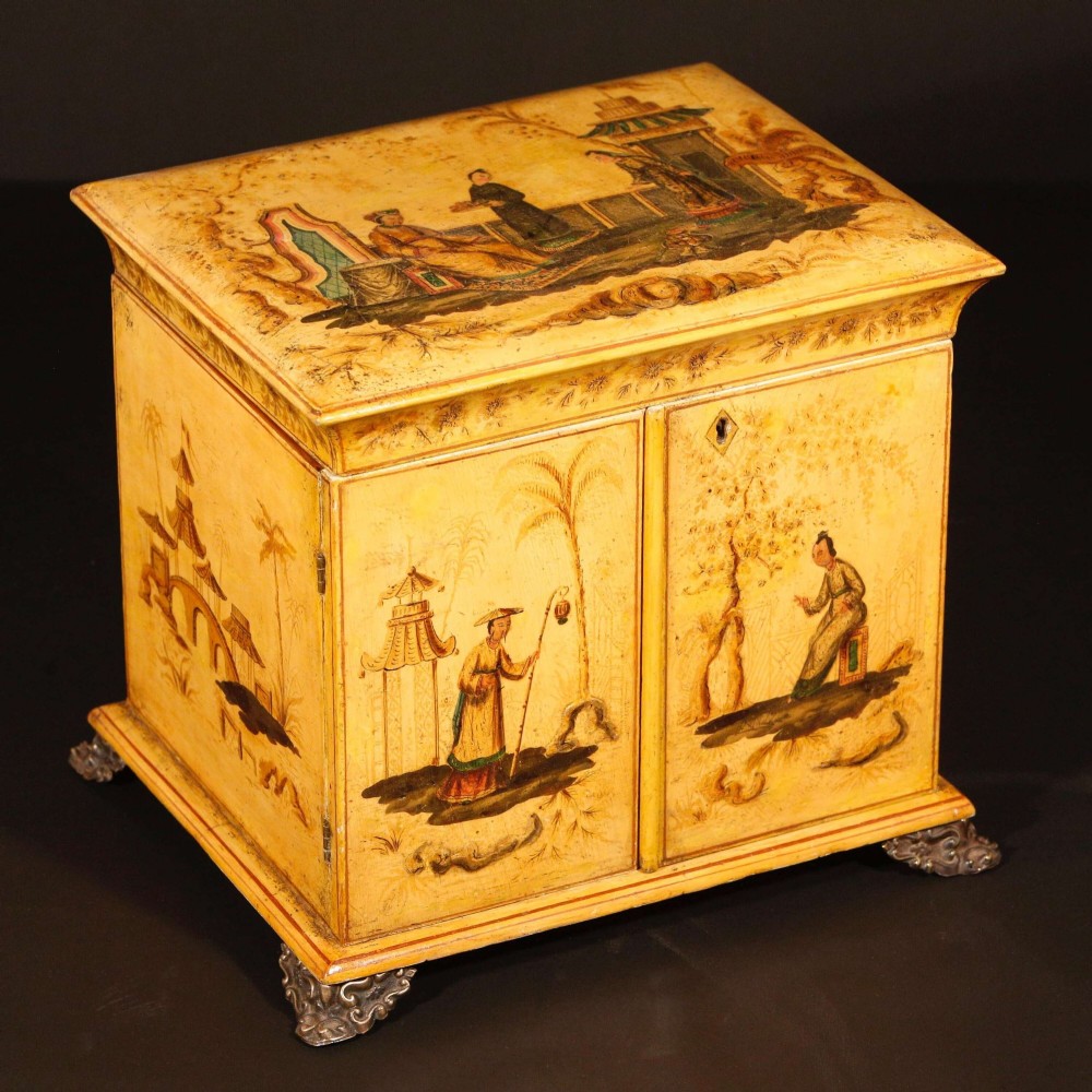 A yellow japanned Regency table cabinet decorated with hand-painted Chinoiserie figures and architecture, elevated on ornate metal feet. View V