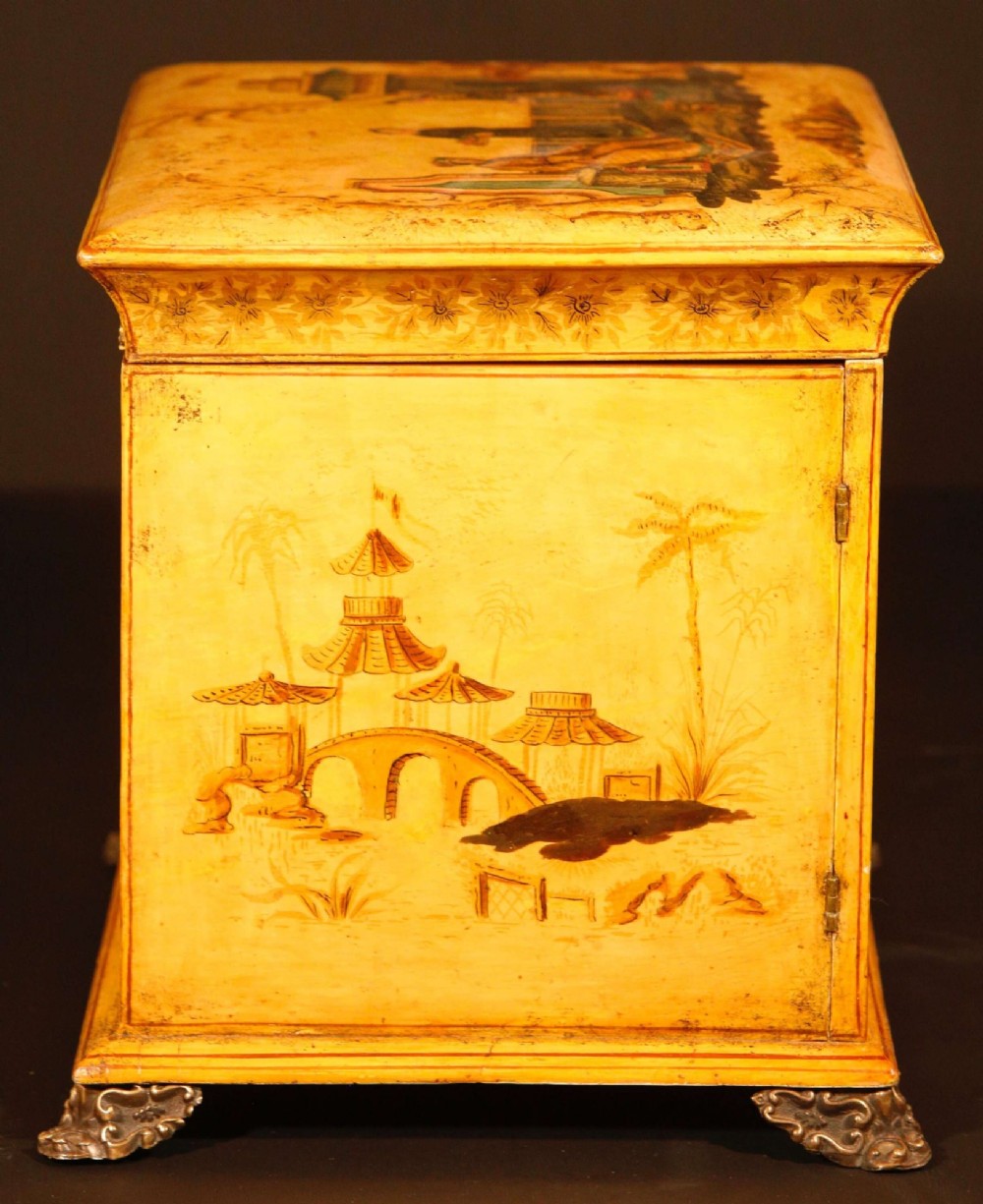 A yellow japanned Regency table cabinet decorated with hand-painted Chinoiserie figures and architecture, elevated on ornate metal feet. View VII