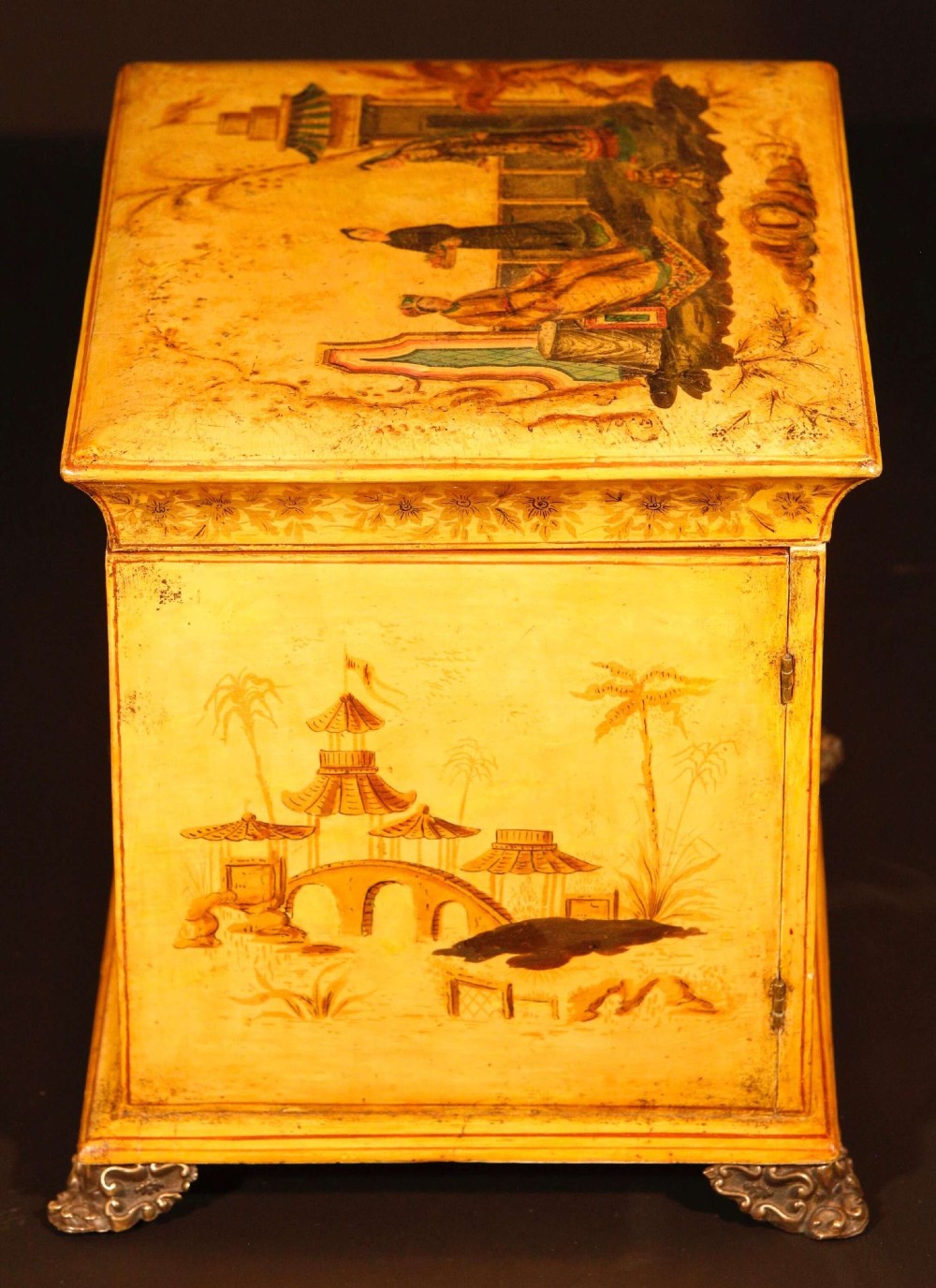 A yellow japanned Regency table cabinet decorated with hand-painted Chinoiserie figures and architecture, elevated on ornate metal feet. View VIII