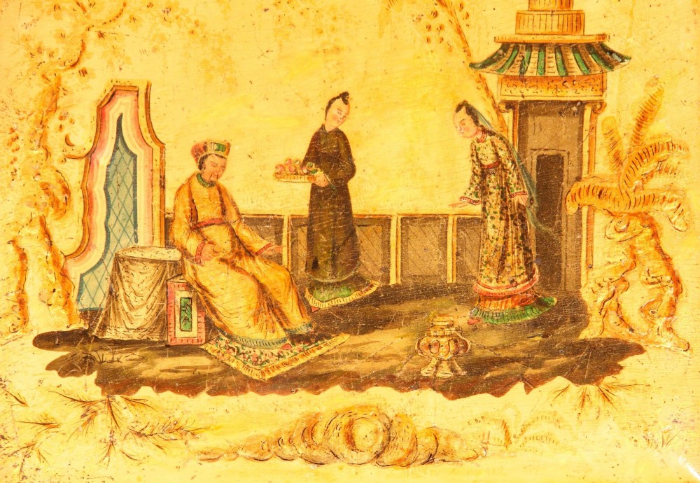 A yellow japanned Regency table cabinet decorated with hand-painted Chinoiserie figures and architecture, elevated on ornate metal feet. View X