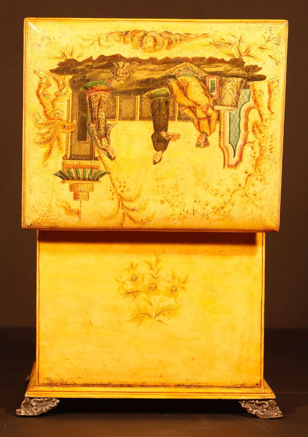 A yellow japanned Regency table cabinet decorated with hand-painted Chinoiserie figures and architecture, elevated on ornate metal feet. View XI