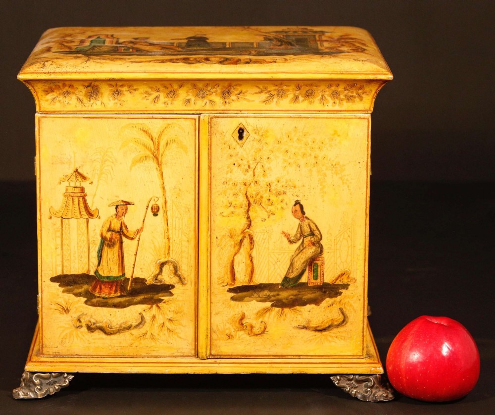 A yellow japanned Regency table cabinet decorated with hand-painted Chinoiserie figures and architecture, elevated on ornate metal feet. View XIV