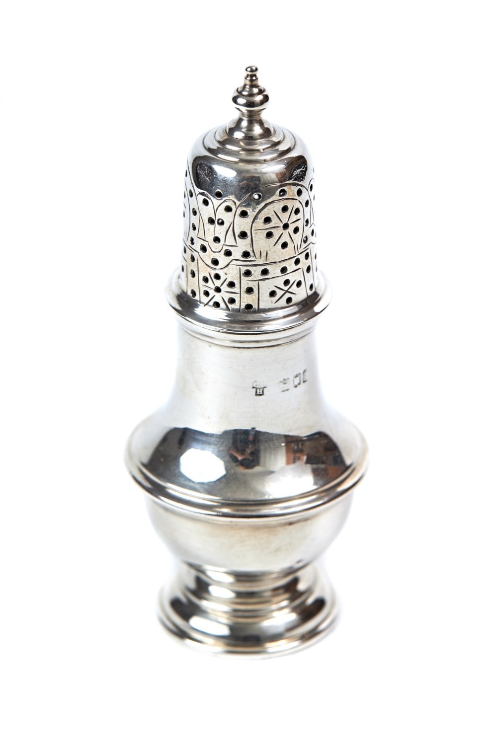 An antique silver pepper caster featuring a baluster-shaped body, a urn finial, and a decorative pierced cover.