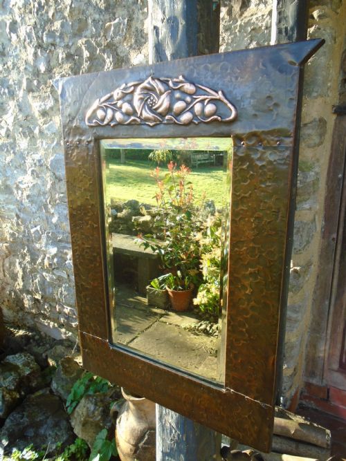 Arts & Crafts copper mirror with a central rose to top.