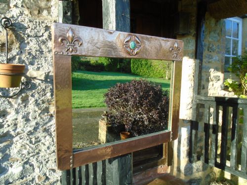 Arts & Crafts copper mirror with a cabochon to top