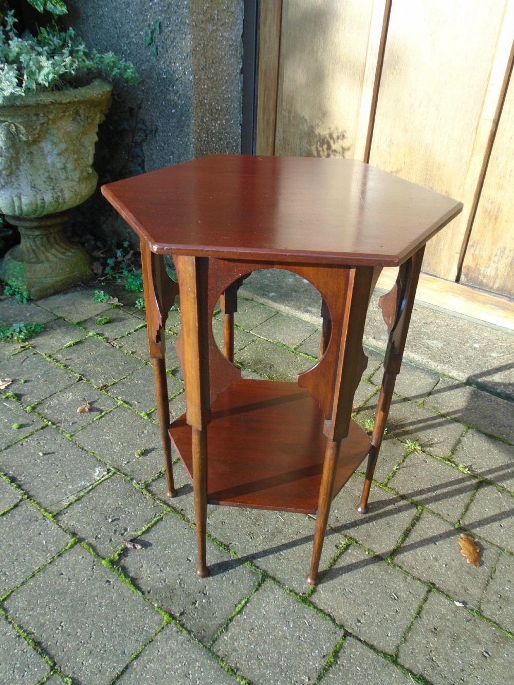 A hexagonal walnut side table featuring carved Moorish horseshoe arches, turned legs, and a lower hexagonal tier. View III