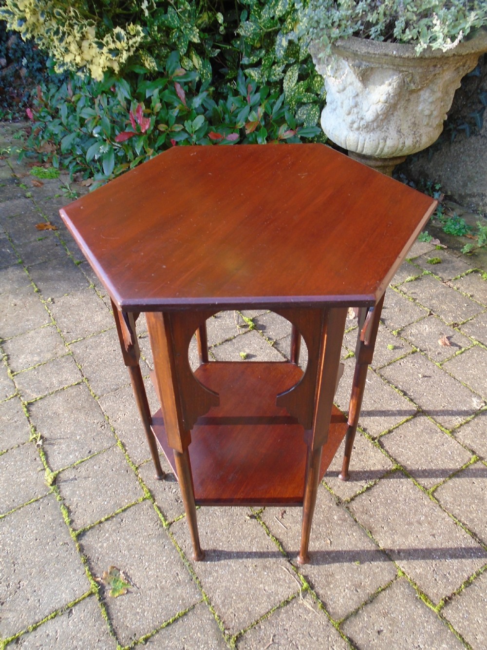 A hexagonal walnut side table featuring carved Moorish horseshoe arches, turned legs, and a lower hexagonal tier. View VI