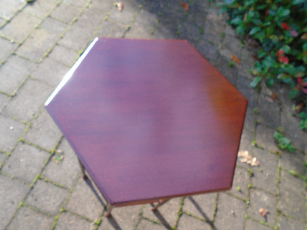 A hexagonal walnut side table featuring carved Moorish horseshoe arches, turned legs, and a lower hexagonal tier. View VII