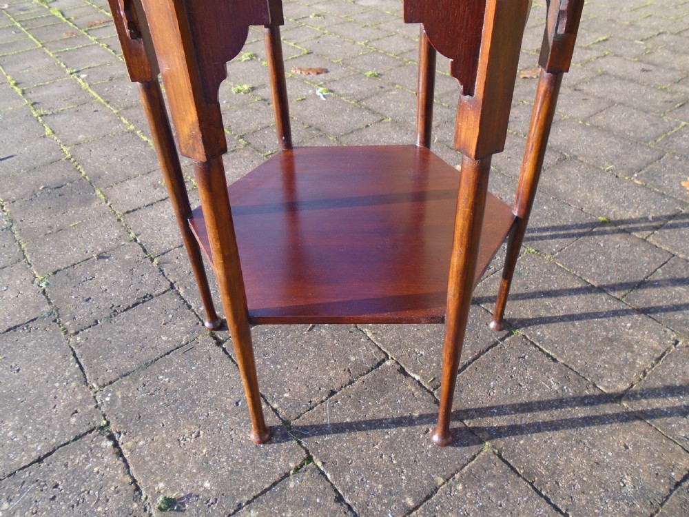 A hexagonal walnut side table featuring carved Moorish horseshoe arches, turned legs, and a lower hexagonal tier. View VIII