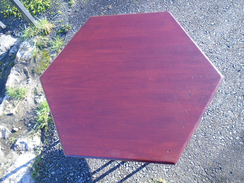 A hexagonal walnut side table featuring carved Moorish horseshoe arches, turned legs, and a lower hexagonal tier. View IX