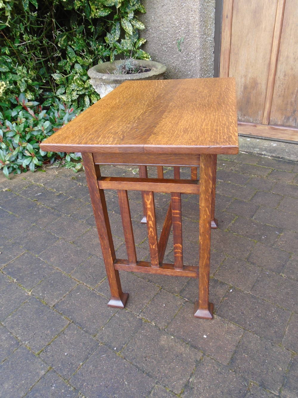 A rectangular Arts and Crafts oak side table featuring slatted side stretchers, square legs with splayed feet, and a flat top. View II